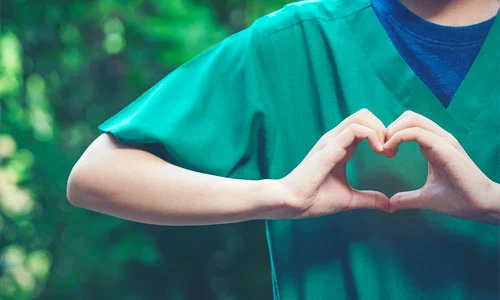 Profesional sanitario formando un corazón con las manos